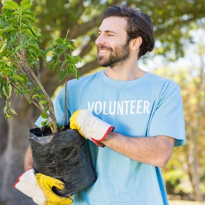 a-volunteer-man-holding-plant-DSXU42K-qaz619h3966jliftp1t7x8p0tywf1w29u4wulqura8